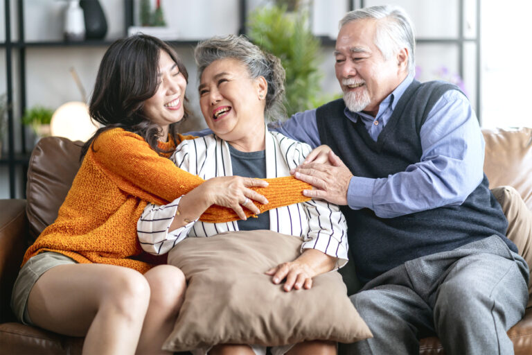 happiness asian family candid daughter hug grandparent mother farther senior elder cozy relax sofa couch surprise visiting living room hometogether hug cheerful asian family home ae·e²
